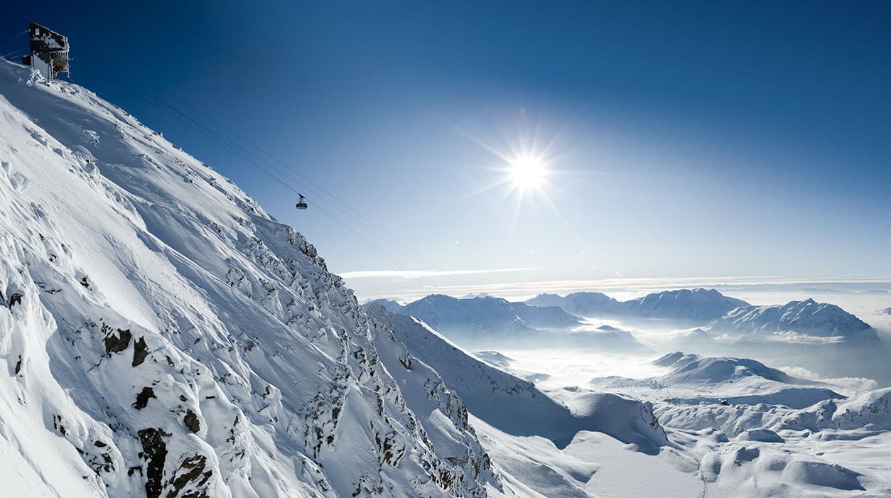 Gondola transporting skiiers to top of mountain in winter ski resort of Alpe D'huez