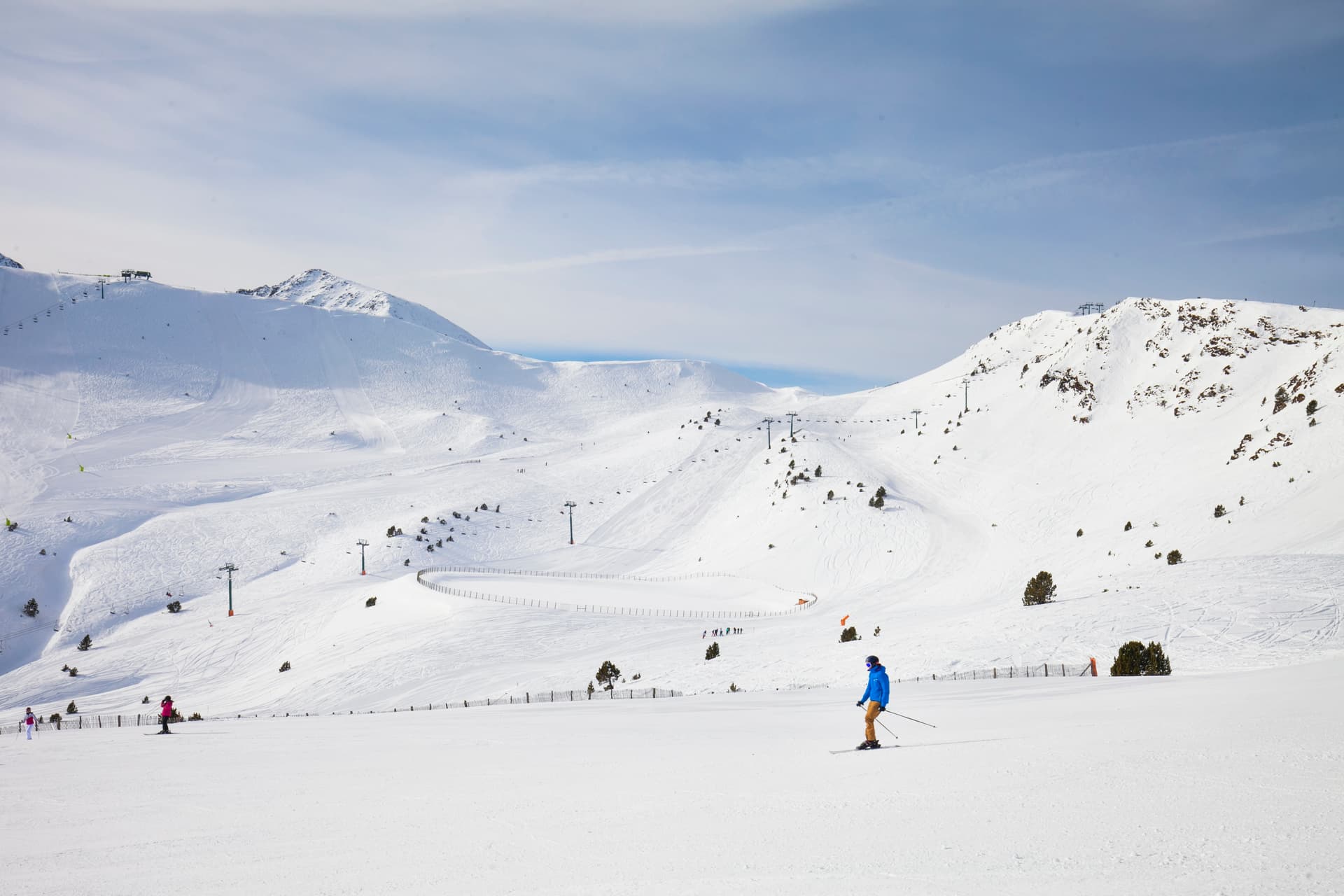 Skiier skiing down wide open slope in Soldeu Andorra