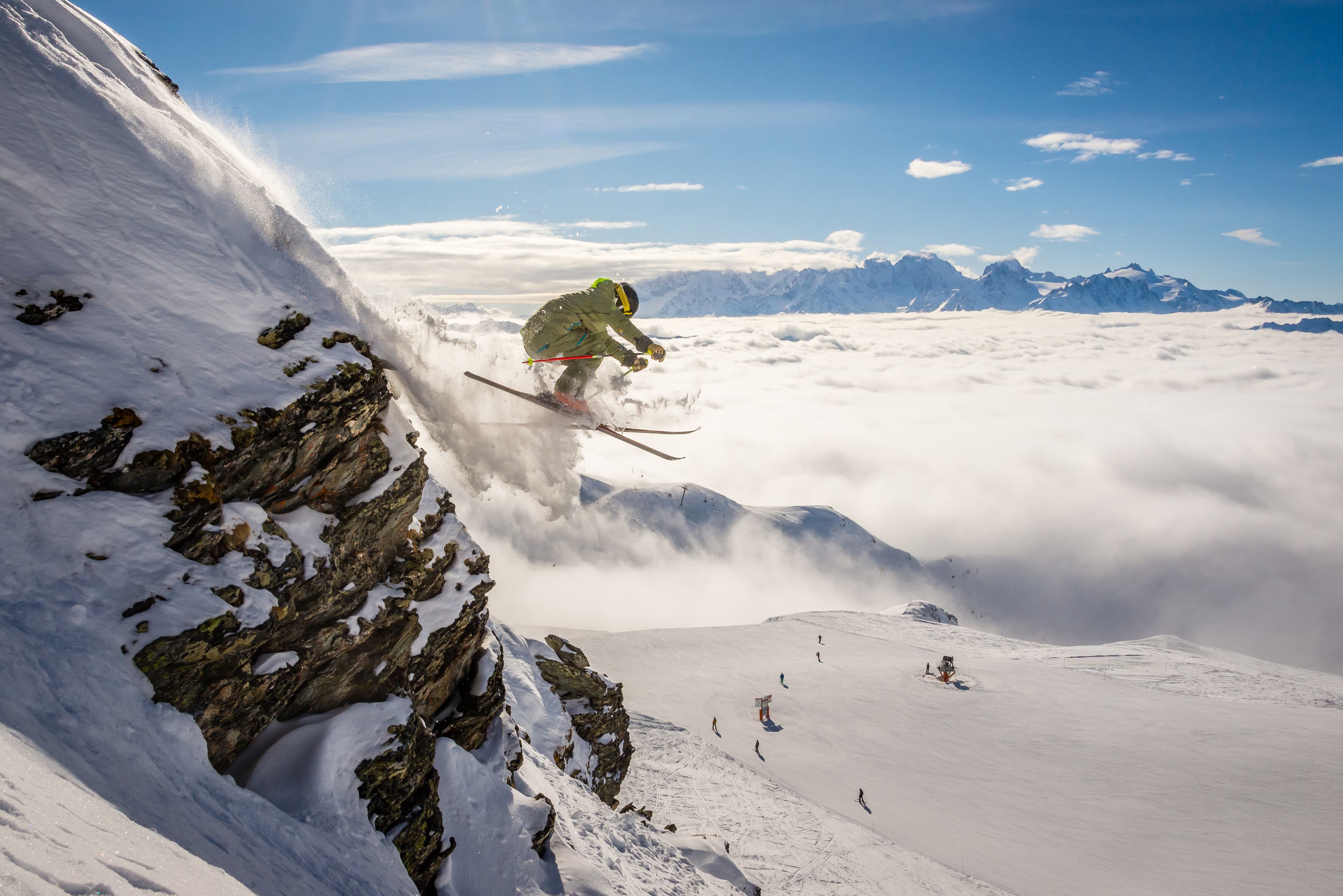 A male skier jumping off a rock, Verbier in the Swiss alps on a switzerland ski holiday