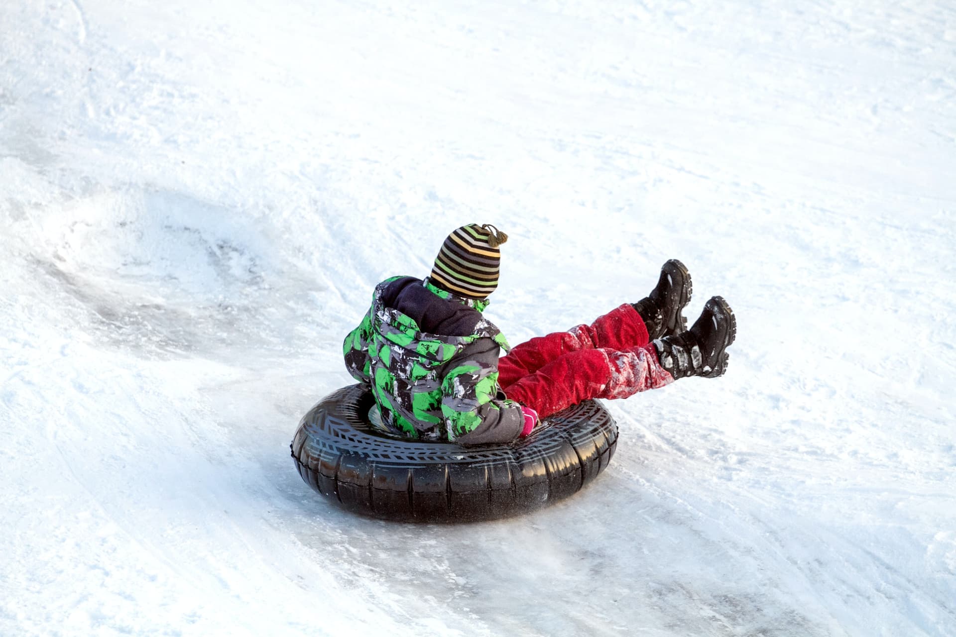 Kid tubing on the mountain