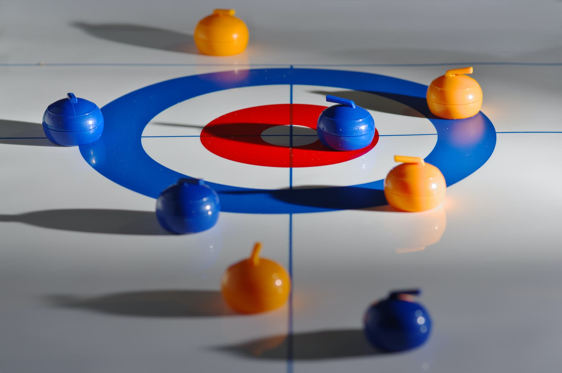 Curling stones on target at ice rink on holiday